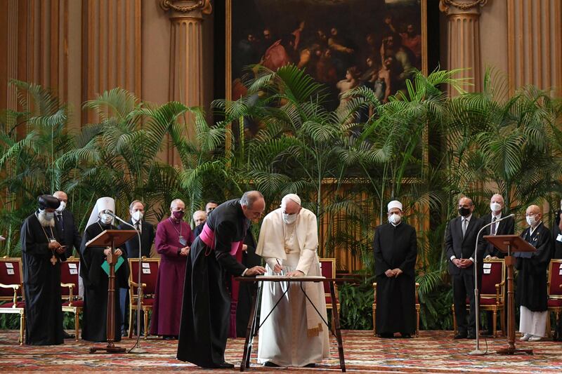 Pope Francis signs the appeal with the current Grand Imam of Al Azhar, Dr Ahmed Al Tayeb, in the background. Photo: AFP