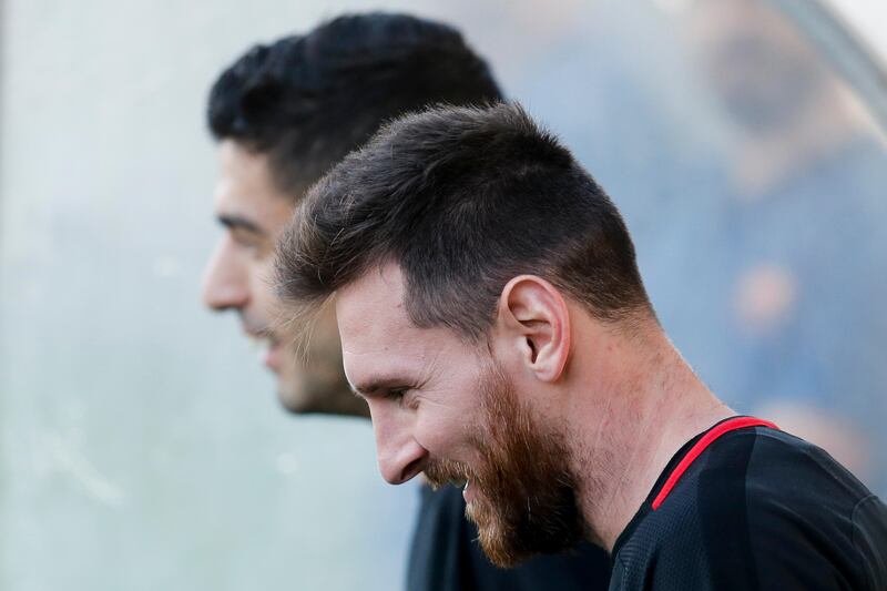 Lionel Messi and Luis Suarez smiles arrive for the training session. Pau Barrena / AFP