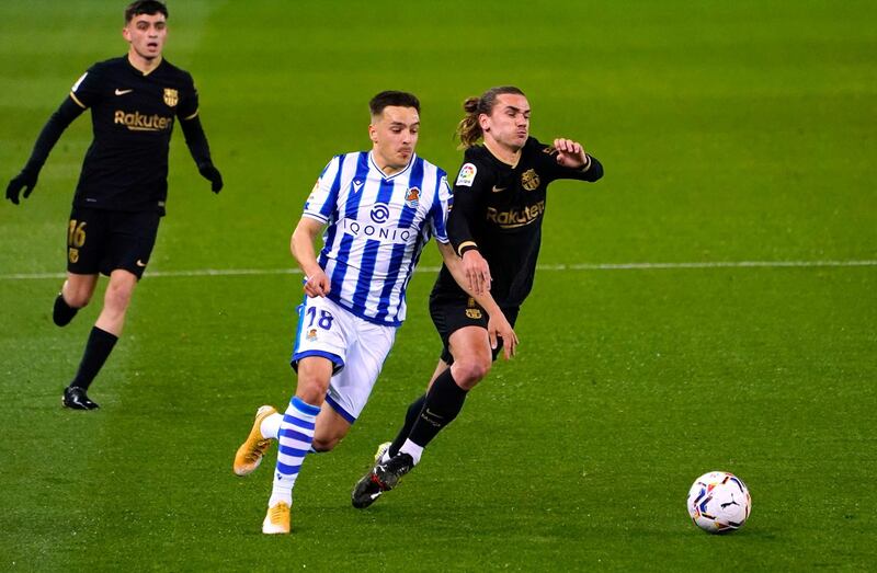 Barcelona's Antoine Griezmann in action with Real Sociedad's Andoni Gorosabel. Reuters