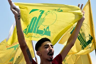 A supporter of Hezbollah carries his party flag during a protest against the visit of Commander of the US Army Central Command, Kenneth Franklin McKenzie to Lebanon at the highway of Rafic Hariri international airport in Beirut, Lebanon, 08 July 2020 EPA