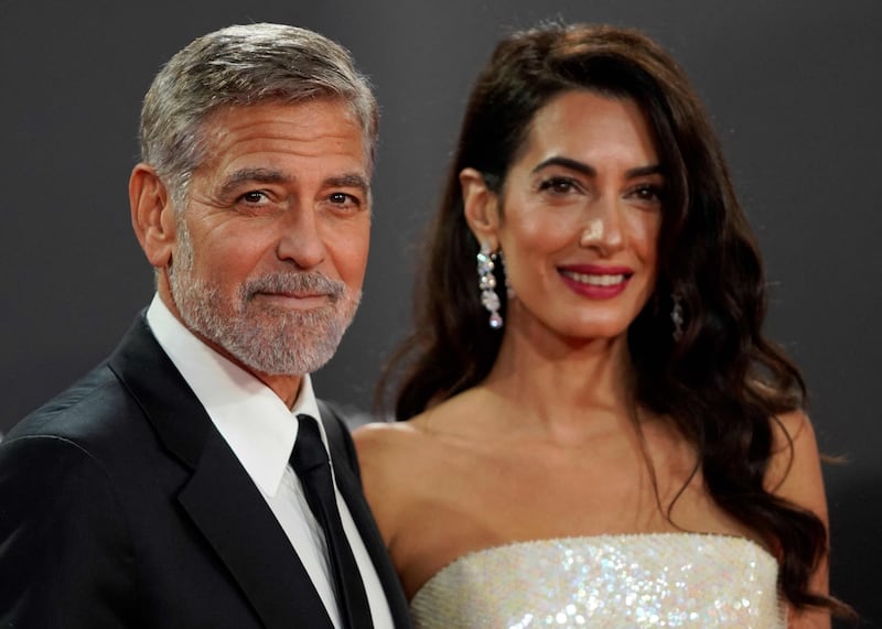 George and Amal Clooney on the red carpet at the UK premiere of the 'The Tender Bar', during the 2021 BFI London Film Festival. AFP