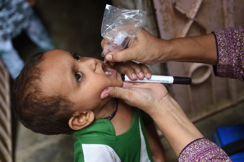 A health worker administers polio drops to a child during a vaccination campaign in Karachi on August 15. Pakistan and Afghanistan are the only countries where polio is endemic. AFP