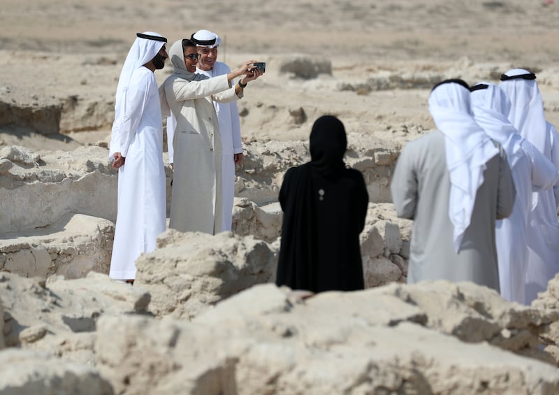 Sheikh Majid bin Saud Al Mualla, left, chairman of the Umm Al Quwain Department of Tourism and Archaeology, leads a tour of the sprawling site.