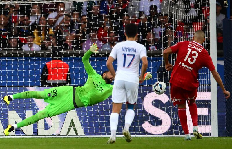 Gianluigi Donnarumma dives to save a penalty. AFP