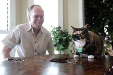 Fred Everitt is all smiles after his cat, Bandit, alerted him in the middle of the night that two men were trying to break into the back door of his home. AP