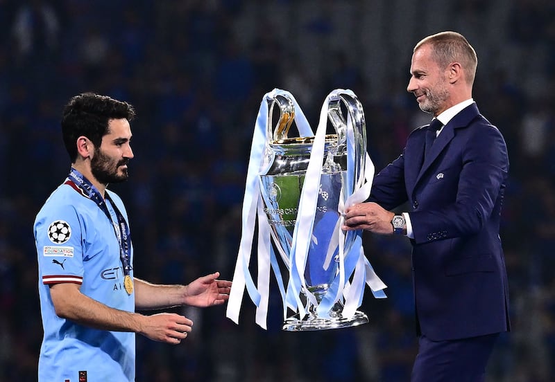 UEFA President President Aleksander Ceferin (R) presents the European Cup trophy to Manchester City's German midfielder #8 Ilkay Gundogan after their win in the UEFA Champions League final football match between Inter Milan and Manchester City at the Ataturk Olympic Stadium in Istanbul. AFP