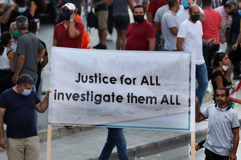 Supporters of Lebanese President Michel Aoun hold a banner during a protest calling for 'truth and justice' weeks after the explosion on August 4, 2020 that devastated Beirut port and parts of the Lebanese capital. AP Photo