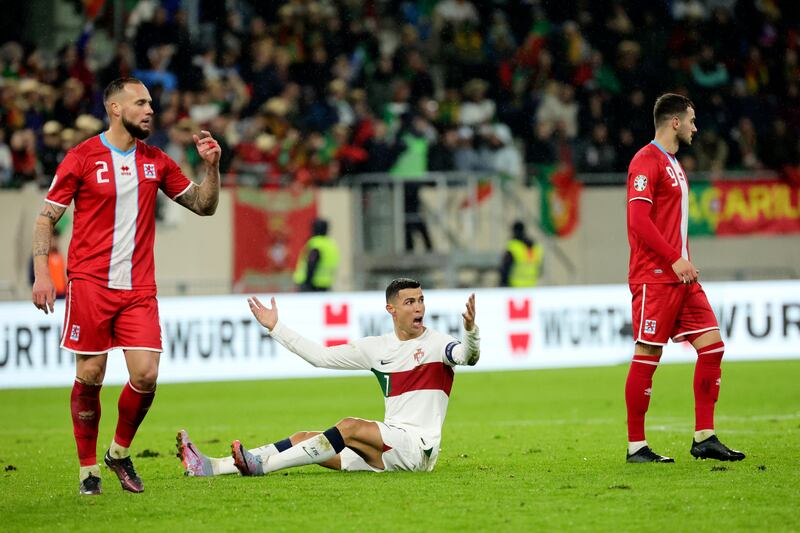 Portugal's Cristiano Ronaldo, centre, reacts after being fouled. AP