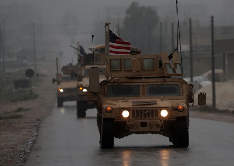 (FILES) In this file photo taken on December 30, 2018, shows a line of US military vehicles in Syria's northern city of Manbij.  President Donald Trump appeared to backtrack on December 31, 2018 on shock plans for an immediate pullout of US troops from Syria, but said his drive to end American involvement in wars made him a "hero." The shift came a day after a senior Republican senator said Trump had promised to stay in Syria to finish the job of defeating the Islamic State group, also known as ISIS. / AFP / Delil SOULEIMAN
