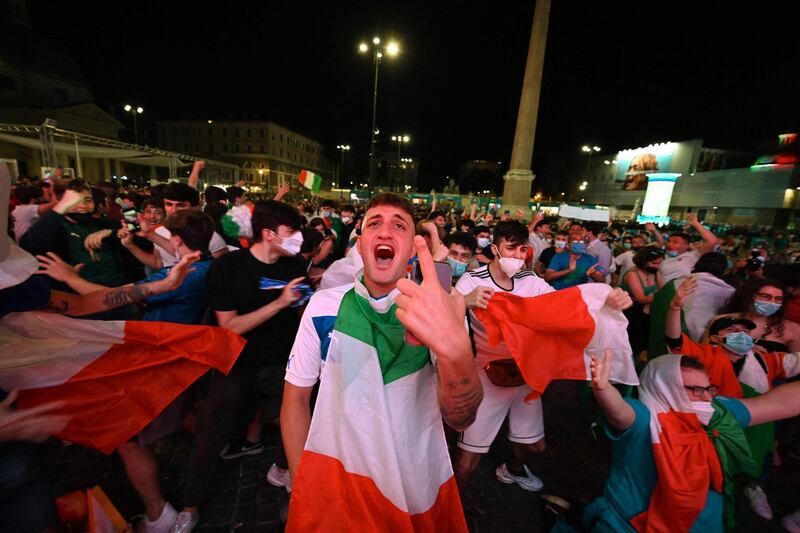 Italy fans celebrate a goal against Turkey while watching from an official fan zone at Piazza del Popolo in Rome. AFP