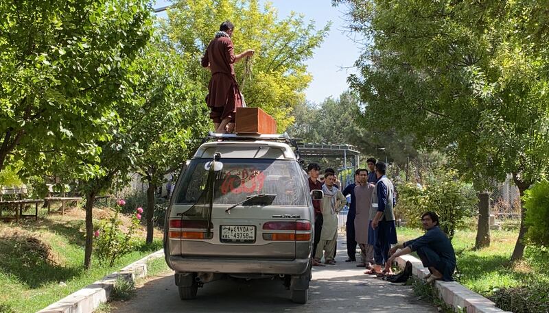 Relatives retrieve the body of a loved one killed in the airport bomb attack in Kabul, Afghanistan.  EPA