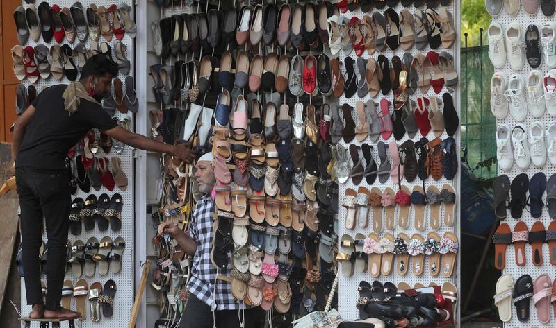 A shoe seller arranges his display in Mumbai. AP Photo