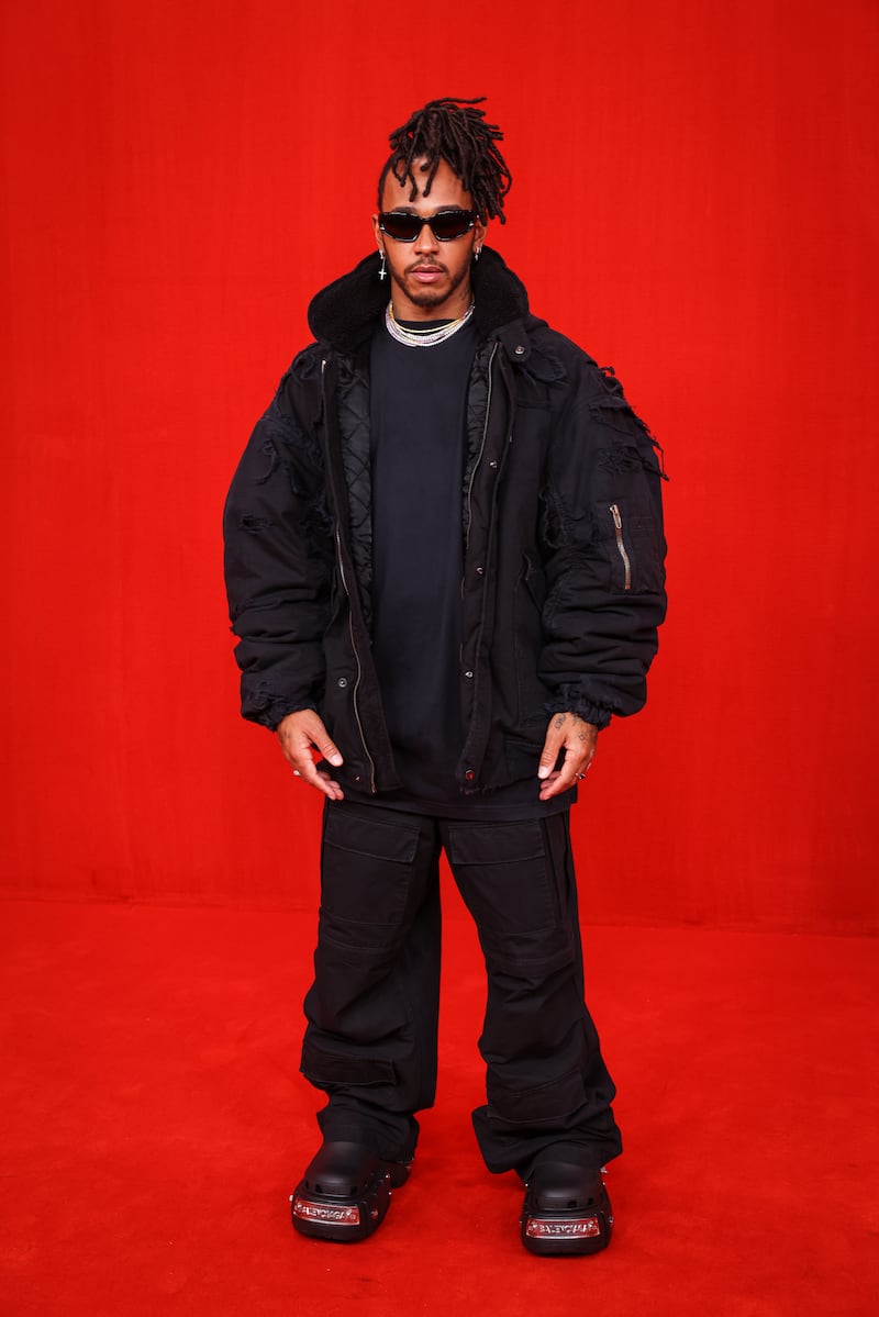 Lewis Hamilton, in black Balenciaga, poses on the catwalk during the Balenciaga spring/summer 2022 show during Paris Fashion Week on October 02, 2021, in Paris. Getty Images