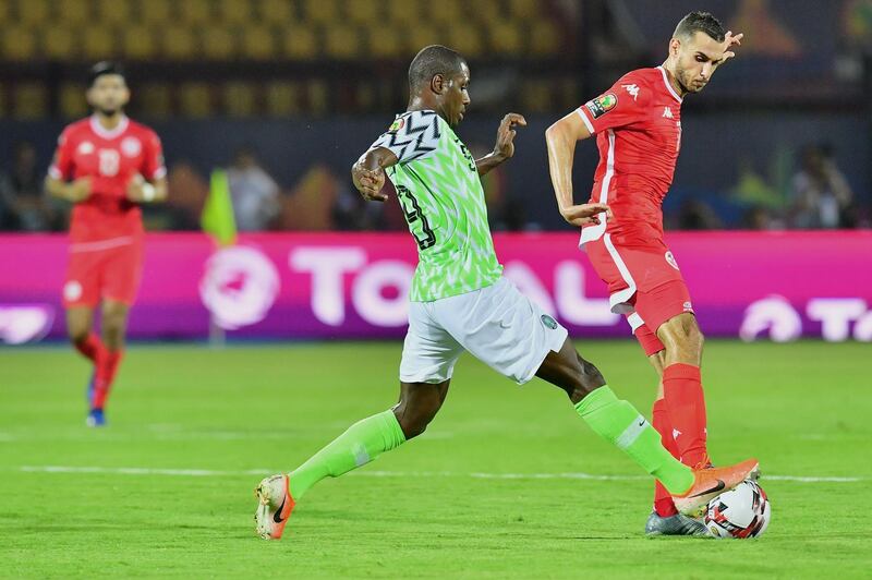 Ighalo makes a challenge against Tunisia. AFP