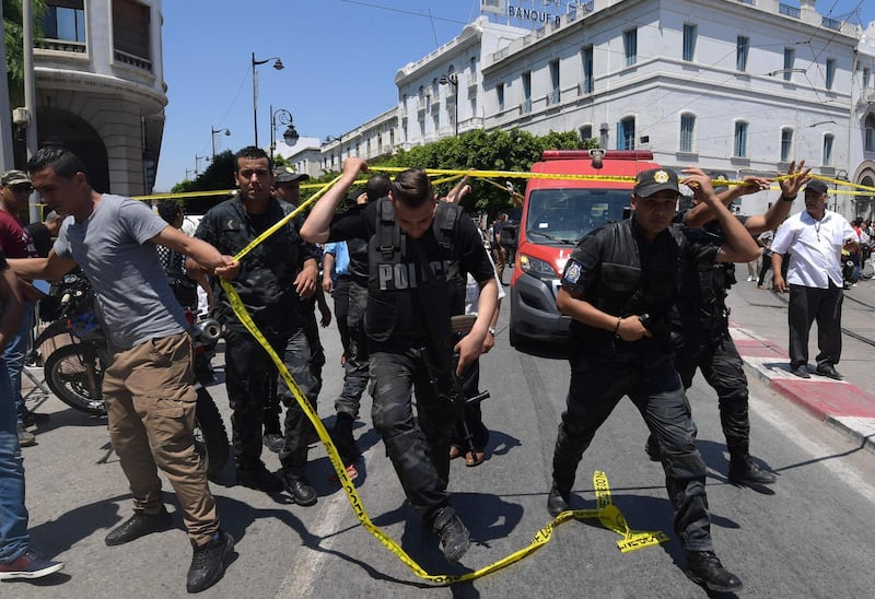 Tunisian police work at the site of an attack in the Tunisian capital's main avenue Habib Bourguiba.  AFP