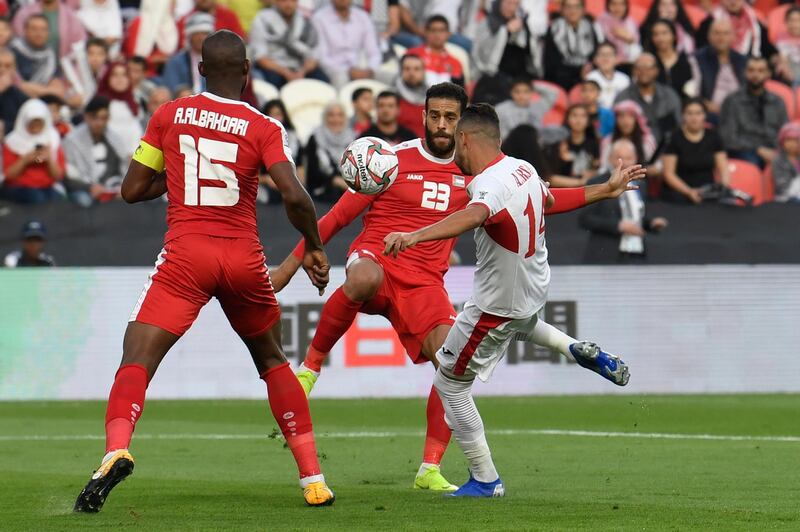 Jordan's Ahmad Ersan, right, is marked by Palestine's Mohammed Darwish and Abdellatif Bahdari. AFP