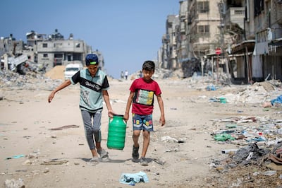 Palestinian children carry water in Khan Younis, in the southern Gaza Strip. AFP