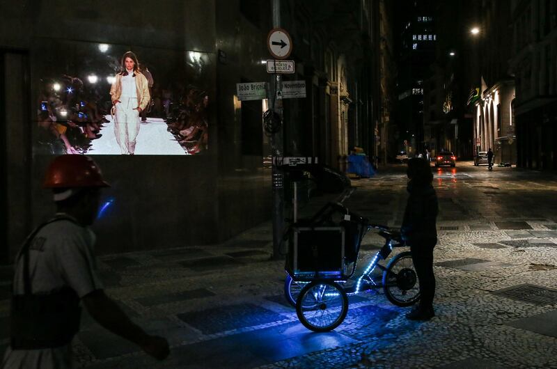 A bicycle with a projection system projects photos on a wall in celebration of 25 years of Sao Paulo Fashion Week in downtown Sao Paulo, Brazil. Getty Images