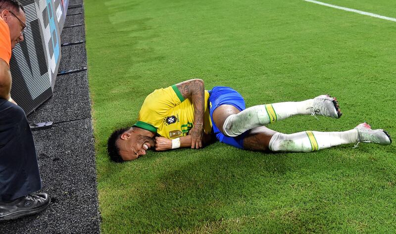 Neymar writhes in pain after after colliding with the boards on the side of the pitch. Credit: Steve Mitchell-USA TODAY Sports