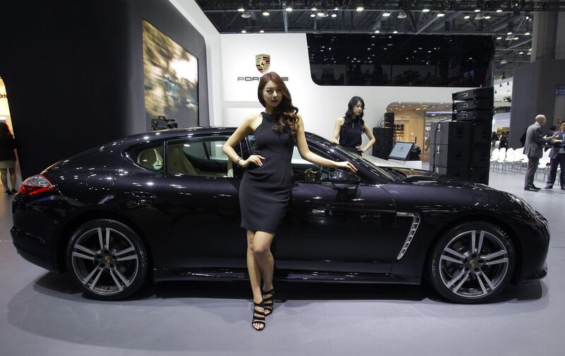 GOYANG, SOUTH KOREA - MARCH 28:  Models pose next to a Porsche Panamera Platium Edition at the Seoul Motor Show 2013 on March 28, 2013 in Goyang, South Korea. The Seoul Motor Show 2013 will be held in March 29-April 7, featuring state-of-the-art technologies and concept cars from global automakers. The show is its ninth since the first one was held in 1995. About 384 companies from 14 countries, including auto parts manufacturers and tire makers, will set up booths to showcase trends in their respective industries, and to promote their latest products during the show.  (Photo by Chung Sung-Jun/Getty Images) *** Local Caption ***  164770476.jpg