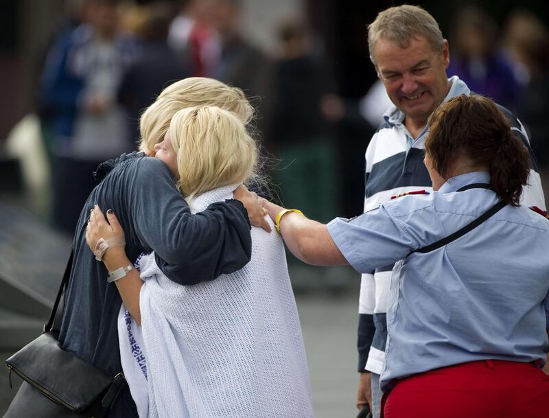 A survivor (2nd,L) of the Utoeya island shooting at the Norwegian Labour Party youth summer camp is reunited with her parents at Sundvolden, some 40 km south west of Oslo, on July 23 , 2011.  At least 91 were killed in Friday's attacks in Norway, a bombing in central Oslo and a shooting spree on an island just outside the capital, and the figure could rise, a senior police officer said. Police had also found explosives on the island of Utoeya, where a gunman opened fire on young people at a summer camp organised by the ruling Labour Party, Sveinung Sponheim, acting commissioner for Oslo police, told reporters. AFP PHOTO / ODD ANDERSEN
 *** Local Caption ***  476264-01-08.jpg