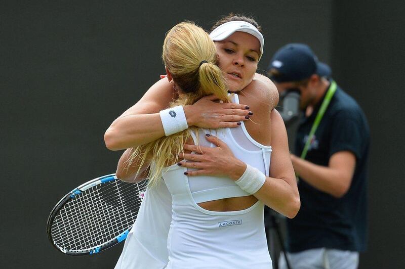 Poland's Agnieszka Radwanska, right, embraces Slovakia's Dominika Cibulkova after losing her women's singles fourth round match on Day 8 of the 2016 Wimbledon Championships at The All England Lawn Tennis Club in Wimbledon, southwest London, on July 4, 2016. AFP / GLYN KIRK