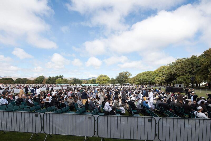 People listen the Adhan, the call for prayer, during a gathering for congregational Friday prayers and to observe two minutes of silence for victims of the twin mosque massacre, at Hagley Park in Christchurch on March 22, 2109.  AFP