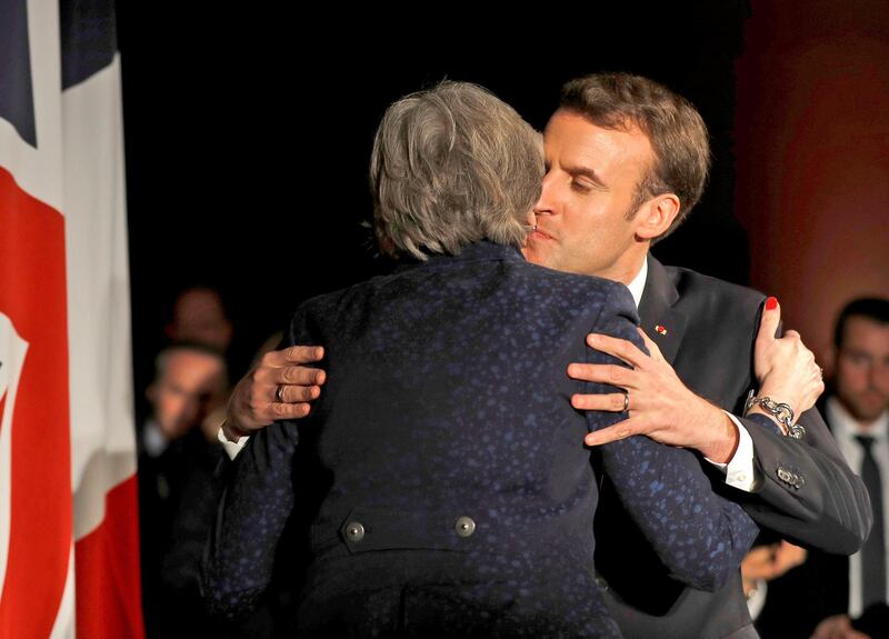 Britain's Prime Minister Theresa May, right, and France's President Emmanuel Macron, during an official dinner at the Victoria & Albert Museum in central London following UK-France summit talks, Thursday Jan. 18, 2018.  Macron said the U.K. cannot keep its coveted financial sector access to the European Union after Brexit unless it continues to play by the bloc's rules, but the leaders also pledged closer cooperation on defense, security and borders. (Peter Nicholls/Pool via AP)