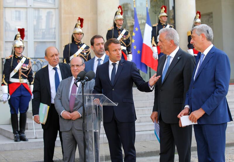 From left to right, French Foreign Minister Jean-Yves Le Drian, Director of the United Nations Migration Agency Antonio Manuel de Carvalho Ferreira Vitorino, French Interior Minister Christophe Castaner, French President Emmanuel Macron, European Commissioner for Migration and Home Affairs Dimitris Avramopoulos and United Nations High Commissioner for Refugees (UNHCR) Filippo Grandi meet the media after a meeting at the Elysee Palace in Paris, France, Monday, July 22, 2019. European ministers have met in Paris seeking unity on how to deal with migrants crossing the Mediterranean Sea. (AP Photo/Michel Euler)
