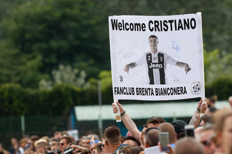 Supporters hold a banner welcoming Ronaldo to Juventus. AP Photo