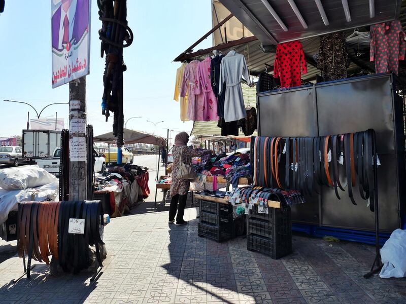 Pictured: A lady browses the clothes of a shop in Zarqa, a city lcoated 30km north east of Amman, where a 16-year-old boy was abducted, raped and tortured in a revenge attack. 
19/10/2020
Photographer: Charlie Faulkner