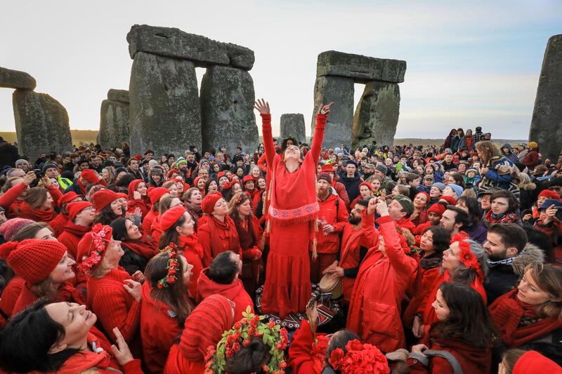 Members of the Shakti Sings choir warble as druids, pagans and revellers gather in the centre of Stonehenge in Wiltshire, England. Getty