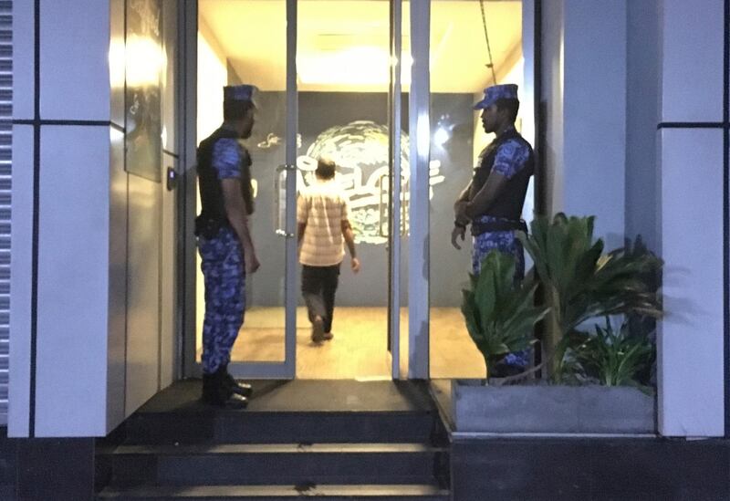 Maldivian policemen stand guard in front of the building housing the election office of the opposition presidential candidate in Male, Maldives, Saturday, Sept. 22, 2018. Maldives police say they have raided the main campaign office of opposition presidential candidate on eve of election. (AP Photo/Eranga Jayawardena)