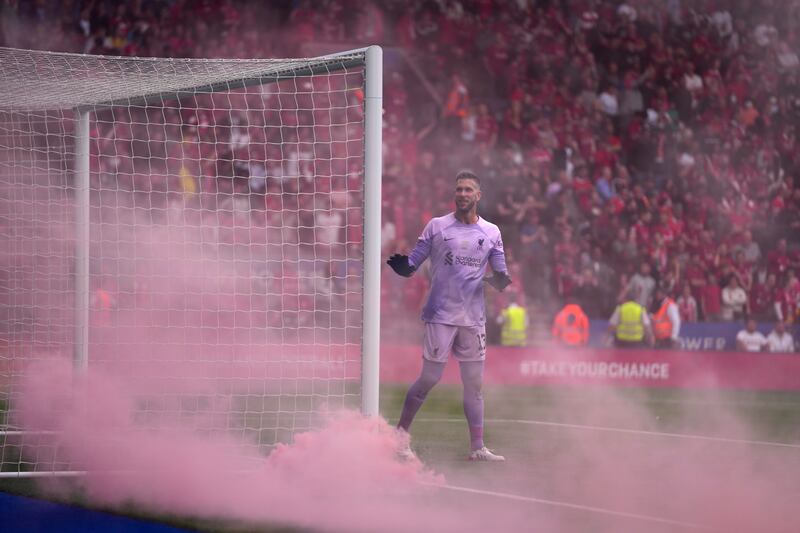 Liverpool's goalkeeper Adrian as fans throw flares after Trent Alexander-Arnold's goal.  AP