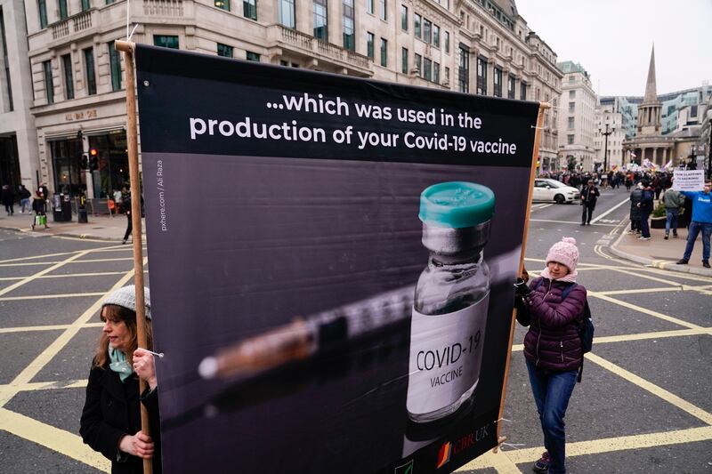 Anti-vaccine protesters with a placard in the UK's capital, London. AP