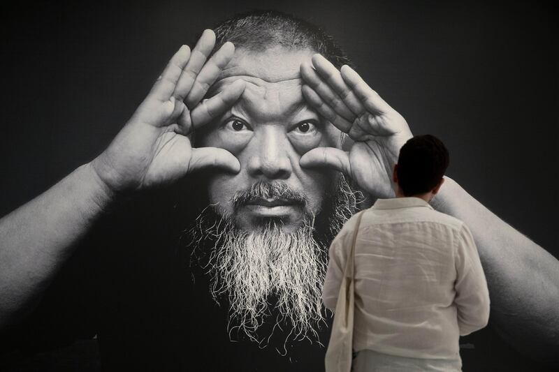 epa06068733 A visitor pauses at a photograph of Chinese artist Ai Weiwei at the exhibit, 'Ai Weiwei Trace at Hirshhorn', at the Hirshhorn Museum and Sculpture Garden in Washington, DC, USA, 05 July 2017. The exhibit featuring internationally famous Chinese artist Ai Weiwei is open to the public through the end of 2017.  EPA/MICHAEL REYNOLDS