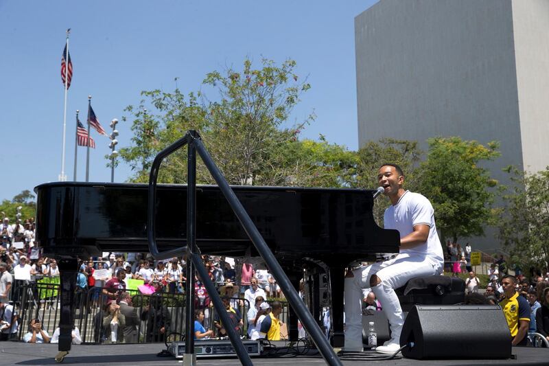 Singer John Legend performs during a rally and march to protest against president Donald Trump’s immigration policies during the Families Belong Together - Freedom for Immigrants March in downtown Los Angeles. Damian Dovarganes / AP Photo
