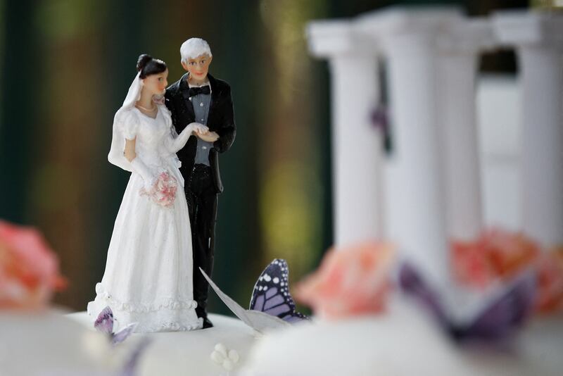 Figurines on top of the cake. Reuters
