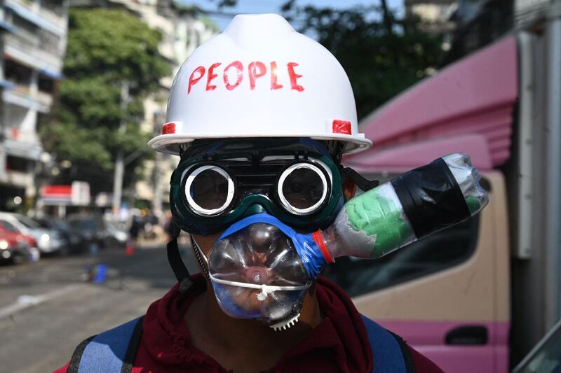 A protester joins a demonstration against the military coup in Yangon, Myanmar, wearing improvised tear gas protection. AFP