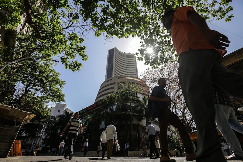 epa07478153 People walk in front of the Bombay Stock Exchange (BSE) in Mumbai, India, 01 April 2019. According to local media reports the BSE's Sensex index touched a record high of 39,115.57 during the day.  EPA/DIVYAKANT SOLANKI