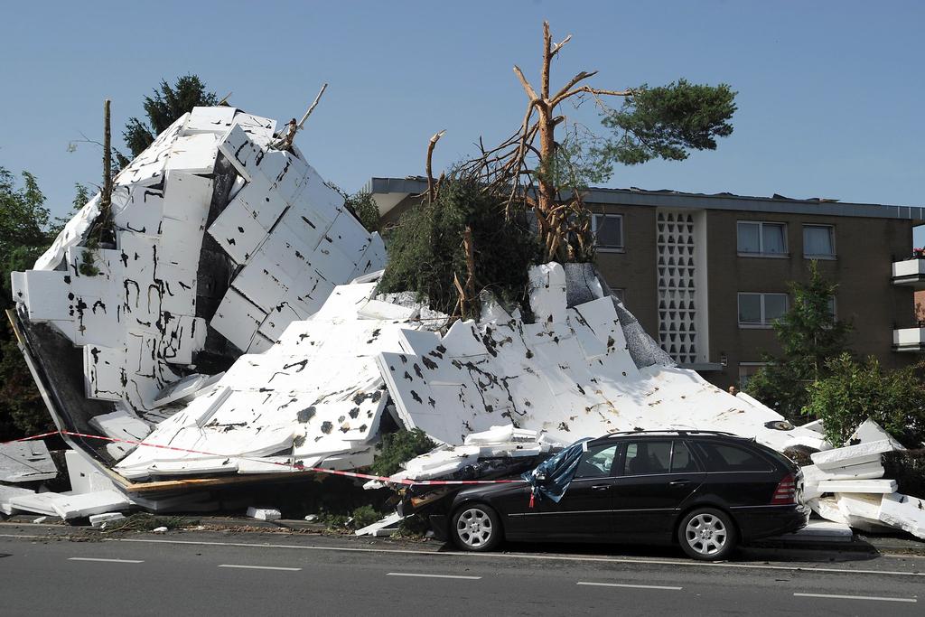 Storms in France, Germany and Belgium in June caused losses amounting $2.7 billion, with $2.5bn of that covered by insurers. Above, the remains of a flat roof lie on the ground in Neuss, Germany. Henning Kaiser / EPA