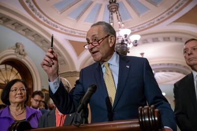 Amid the public outcry over the administration's "zero tolerance" approach to illegal border crossings and the separation of children from parents, Senate Minority Leader Chuck Schumer, D-N.Y., flanked by Sen. Mazie Hirono, D-Hawaii, left, and Sen. Dick Durbin, D-Ill., holds out a pen telling President Donal Trump, "Mr. President you started it, you can stop it," during a news conference on Capitol Hill in Washington, Tuesday, June 19, 2018. (AP Photo/J. Scott Applewhite)