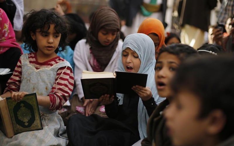 A girl recites the Quran during the Muslim fasting month of Ramadan, at the Grand Mosque in Sanaa, Yemen on June 29, 2014. Khaled Abdullah /Reuters