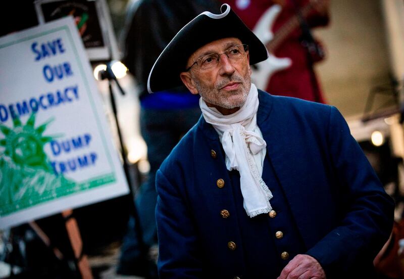 Event organizer Steven Rapport stands amongst the crowd while dressed as one of the US founding fathers, Alexander Hamilton, during a demonstration in San Francisco.  AFP