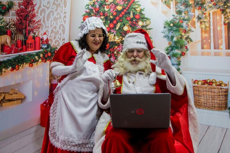 Manoel Miranda de Sousa and his wife perform as Santa Claus and Mrs Claus via live video, in Sao Paulo, Brazil. AP