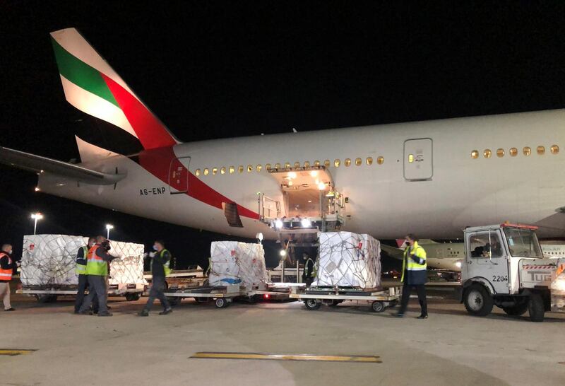 Workers unload the first batch of Covid-19 vaccines arriving in Amman on January 9, 2021. Reuters