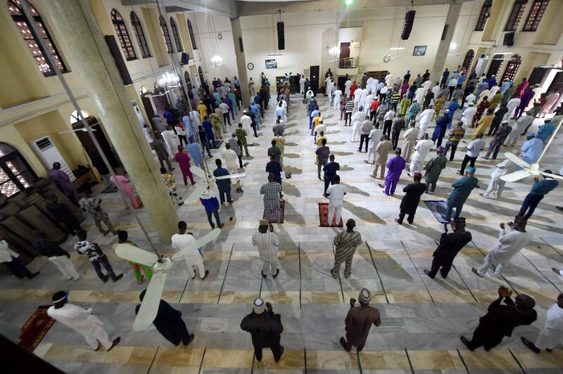 Muslims pray in a mosque for the first time in months in Lagos. Places of worship were closed to prevent the spread of Covid-19 but reopened in early August. Pius Utomi Ekpei / AFP
