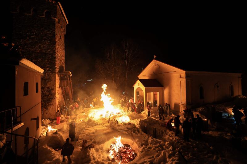 Georgians celebrate Lamproba, a festival honouring the dead by burning fires at their graves, in the Caucasus Mountains, Georgia. AFP