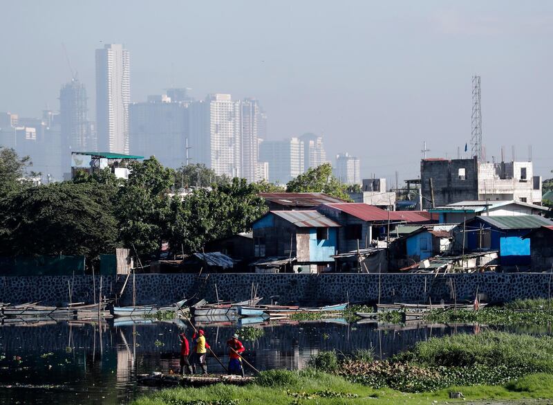 Filipino workers clear water lillies at a wetland in Taguig city, Philippines. Francis R. Malasig / EPA