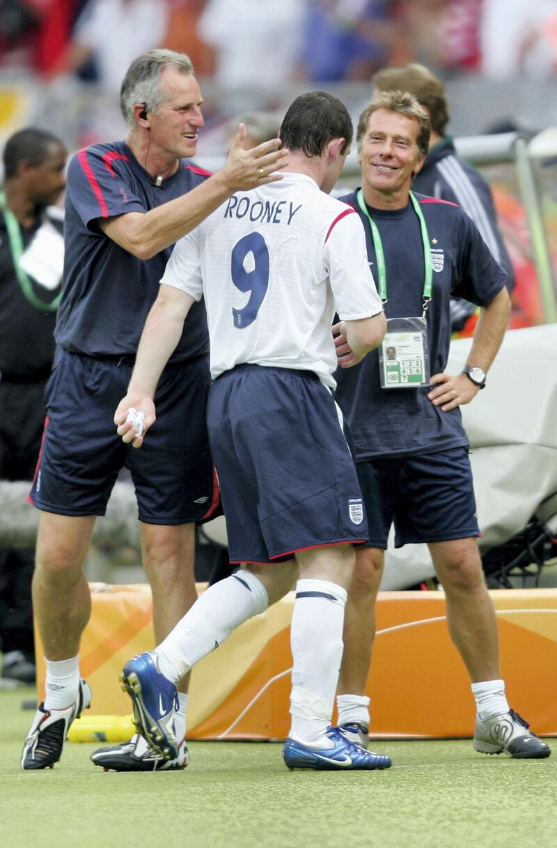 NUREMBERG, GERMANY - JUNE 15:  Wayne Rooney (C) of England, is congratulated by Ray Clemence (L), following their team's 2-0 victory during the FIFA World Cup Germany 2006 Group B match between England and Trinidad and Tobago at the Frankenstadion on June 15, 2006 in Nuremberg, Germany.  (Photo by Ross Kinnaird/Getty Images)